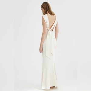 Maxi high neck design with subtle cowl neck, open back, adjustable ties.